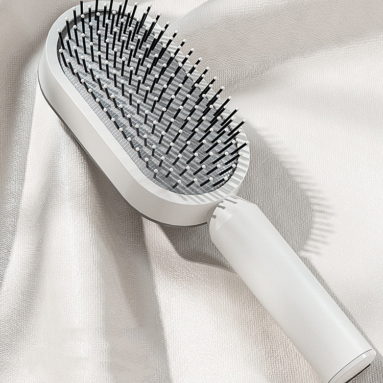 Sleek single piece self cleaning hair brush for women with cushion design