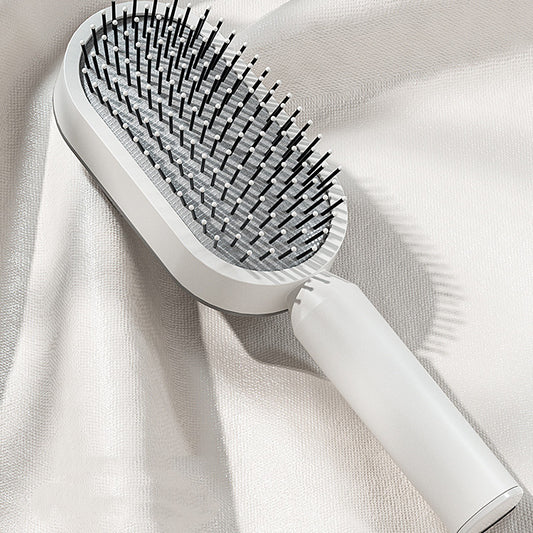 Sleek single piece self cleaning hair brush for women with cushion design
