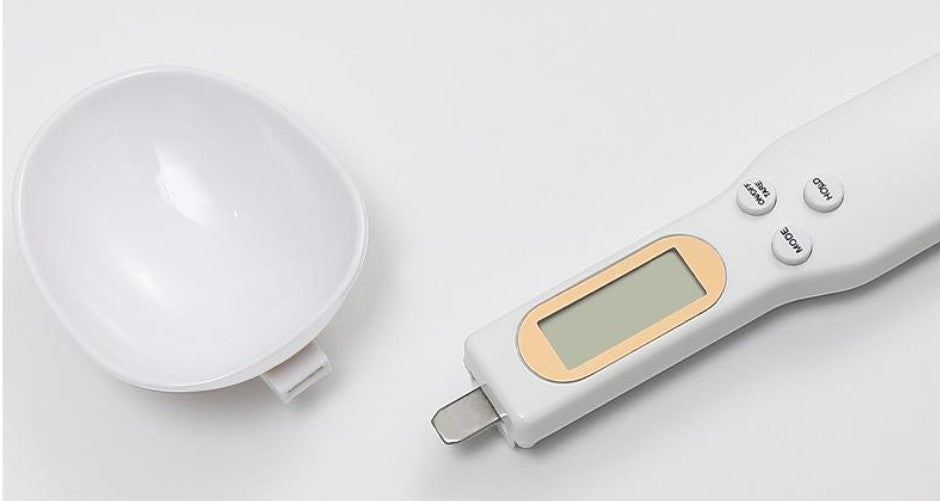 Detachable spoon head being removed from the digital scale handle for cleaning