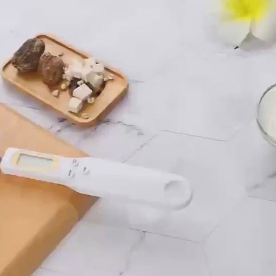 Digital LCD screen on a kitchen spoon scale showing weight in ounces